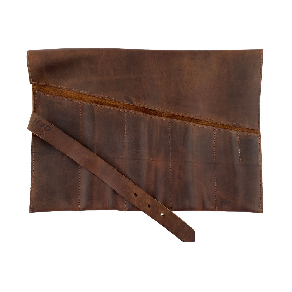 Hide & Drink's Large Tool Roll, designed for convenience with a stylish appearance. This Portable Carry-On Pouch incorporates 6 slots for effective woodworking tools management. Made from waxed canvas and full grain leather variations, this artisan product is hand cut and sewn, representing small batch production handmade in La Antigua Guatemala & Oaxaca Mexico.