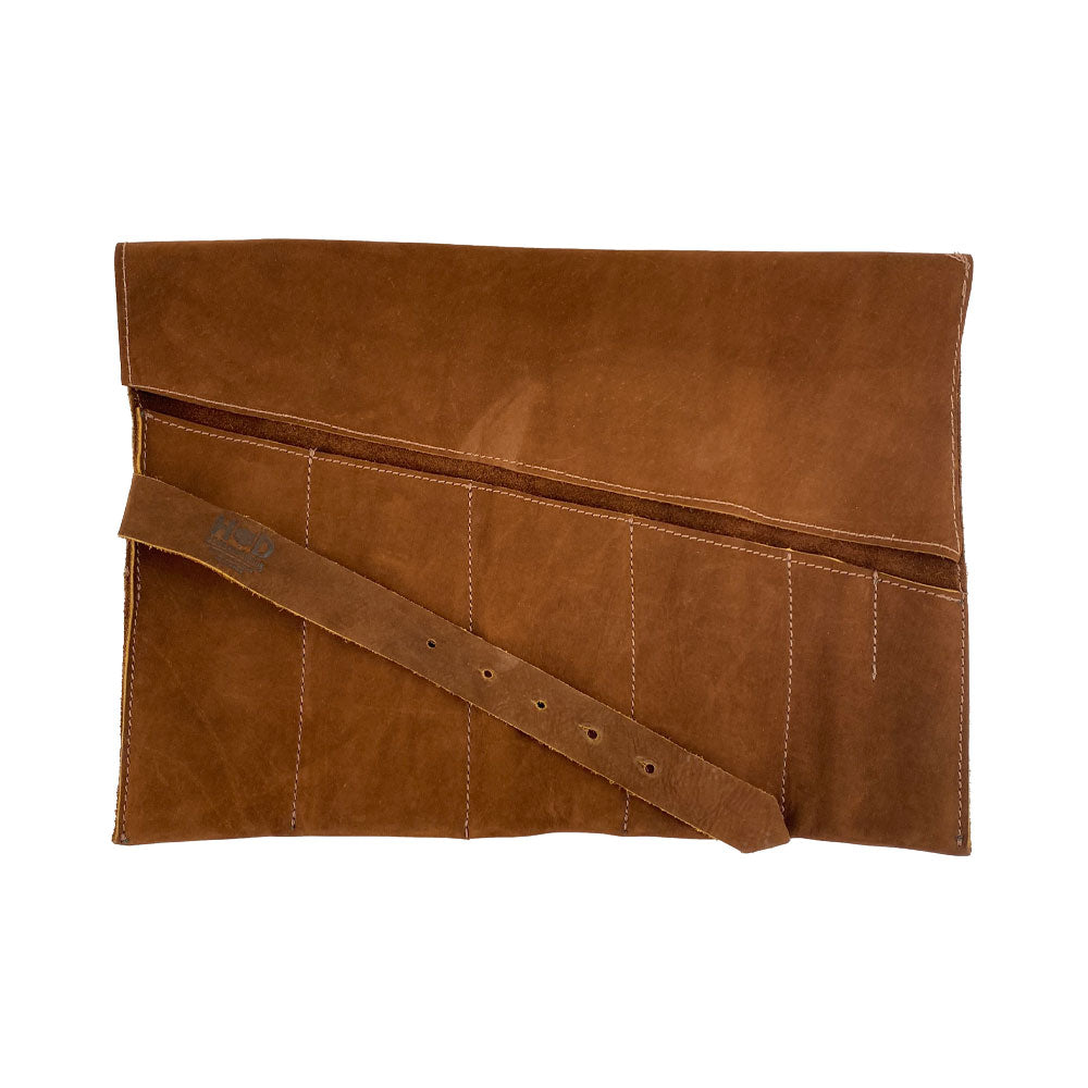 Showcased Large Tool Roll by Hide & Drink, ideal for artists and craftsmen. This Portable Carry-On Pouch includes 6 slots for woodworking tools organization. Made from premium waxed canvas & full grain leather variations, this product represents small batch artisan work, hand cut and hand sewn in La Antigua Guatemala & Oaxaca Mexico.