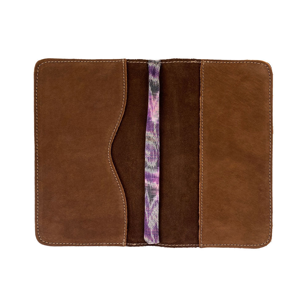 Open view of a brown Journal Cover for Moleskine Cahier L (5 x 8.25 in.) by Hide & Drink with a stylish bookmark. This refillable journal cover is crafted from full grain leather and perfect for large size (5 x 8.25 in.) notebooks.