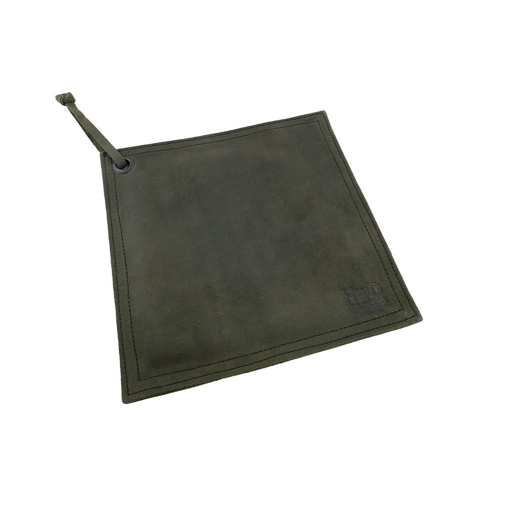 Side view of the Hide & Drink Pot Pad featuring its handcrafted quality and rustic detailing. This artisan pot pad is made for effective heat resistance.