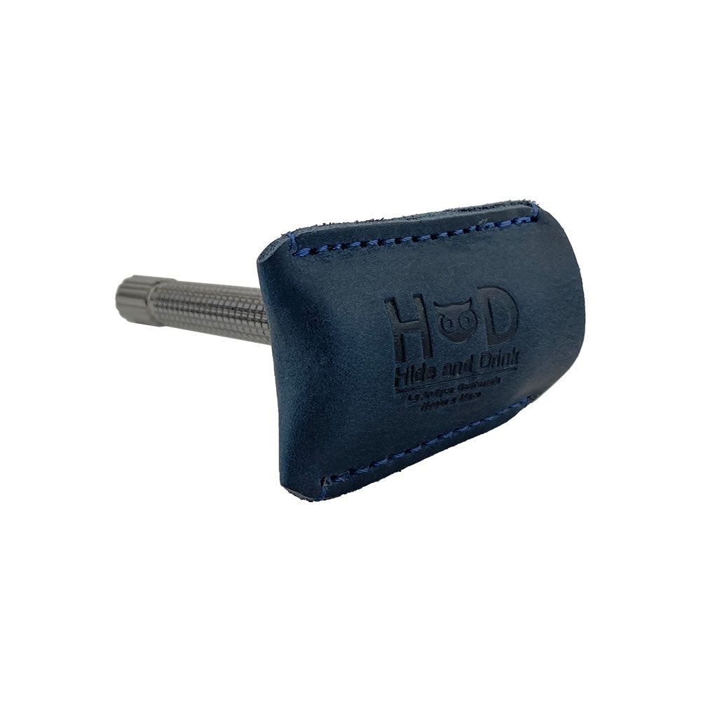 Side view of a Razor Head Cover by Hide & Drink fitted over a double edge safety razor, showcasing the protective sheath design in full grain leather. Ideal for safe traveling, this cover reflects handmade quality and small batch production from La Antigua Guatemala and Oaxaca Mexico.