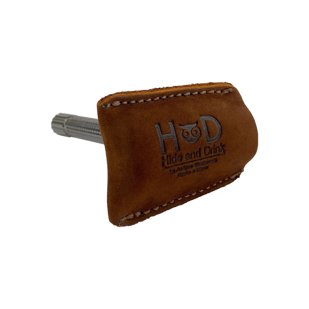 Razor Head Cover by Hide & Drink, displayed with a double edged razor for context. This Full Grain Leather shaving travel cover exemplifies artisan craftsmanship with hand cut and hand sewn features, and a fire branded logo. A perfect Double Edge Safety Razor Head Protective Sheath, made in La Antigua Guatemala & Oaxaca Mexico.