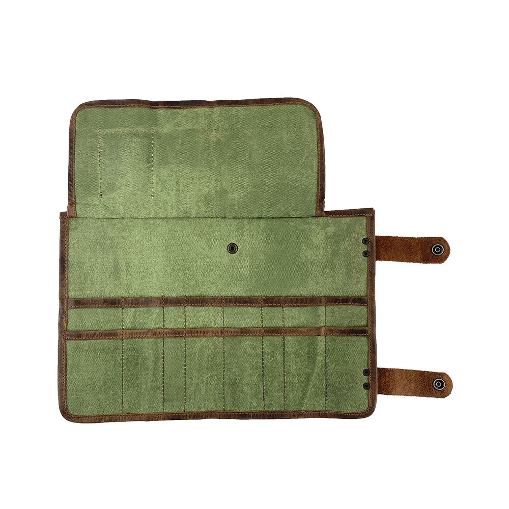 Hide & Drink presents its Barber Tool Roll, showcasing a Snap Tool Roll Up Bag with 14 Slots ideal for scissors & screwdrivers. This portable carry case is made from quality Full Grain Leather, representing StockyardX's small batch production commitment and artisan skills, hand cut, hand sewn, and fire branded in La Antigua Guatemala & Oaxaca Mexico.