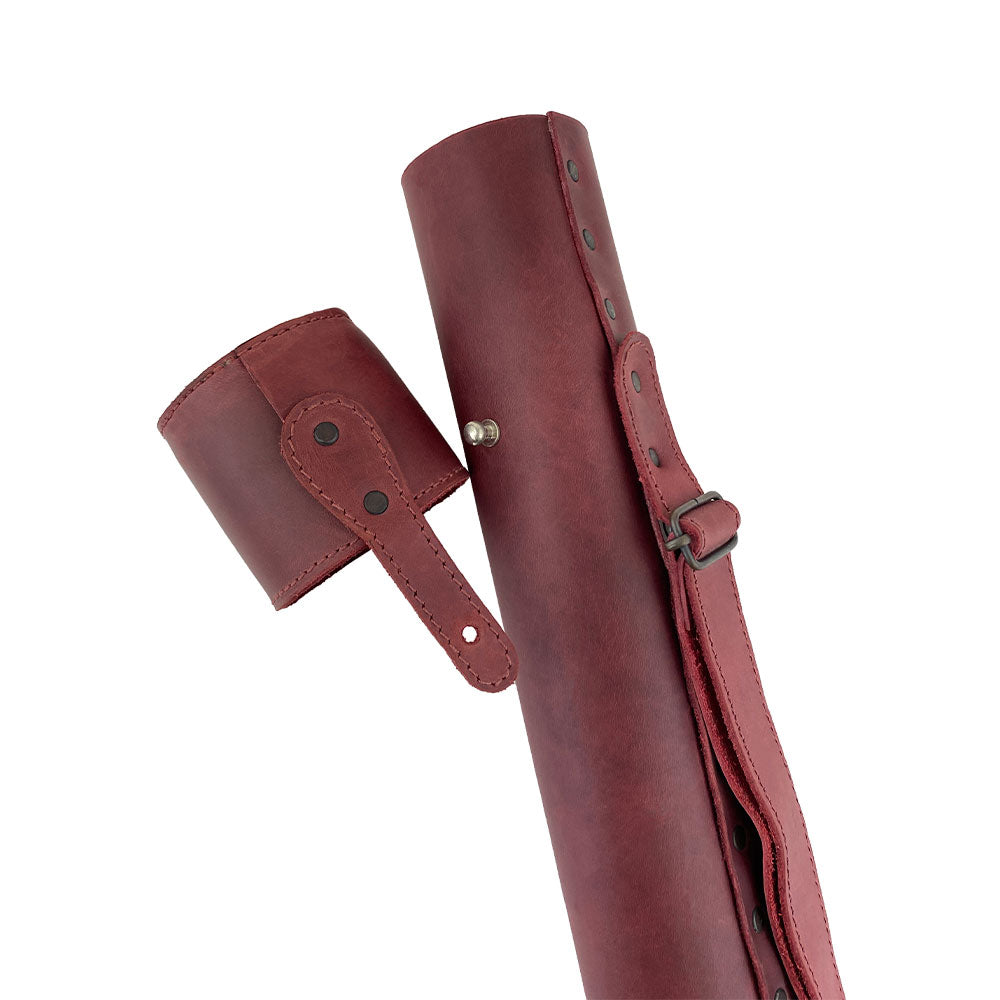 Hide & Drink's Blueprint Tube (A2 Paper Size) shown with red architectural plans. This full grain leather document storage tube features an adjustable strap, perfect for architects, showcasing StockyardX's artisan quality and handmade approach from La Antigua Guatemala & Oaxaca Mexico.