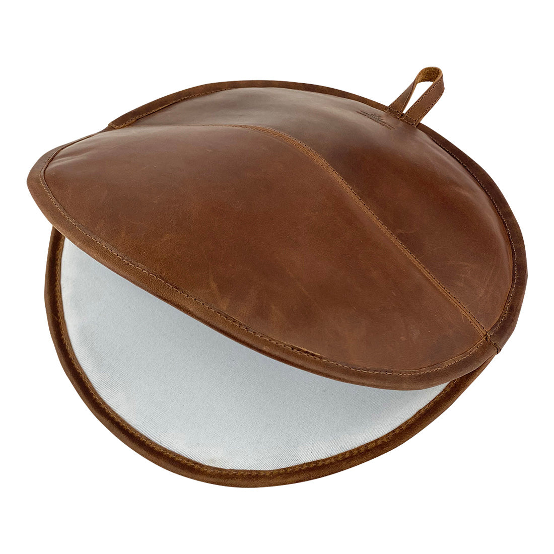 The inside view of a Tortilla Warmer by Cast Leather Co., featuring soft full grain leather, designed to keep your tortillas warm. This is a stylish Tortilla Warmer Pouch, a Fabric Tortilla Heater Pouch, emphasizing small batch production with hand cut and hand sewn craftsmanship, fire branded by artisans in La Antigua Guatemala & Oaxaca Mexico.