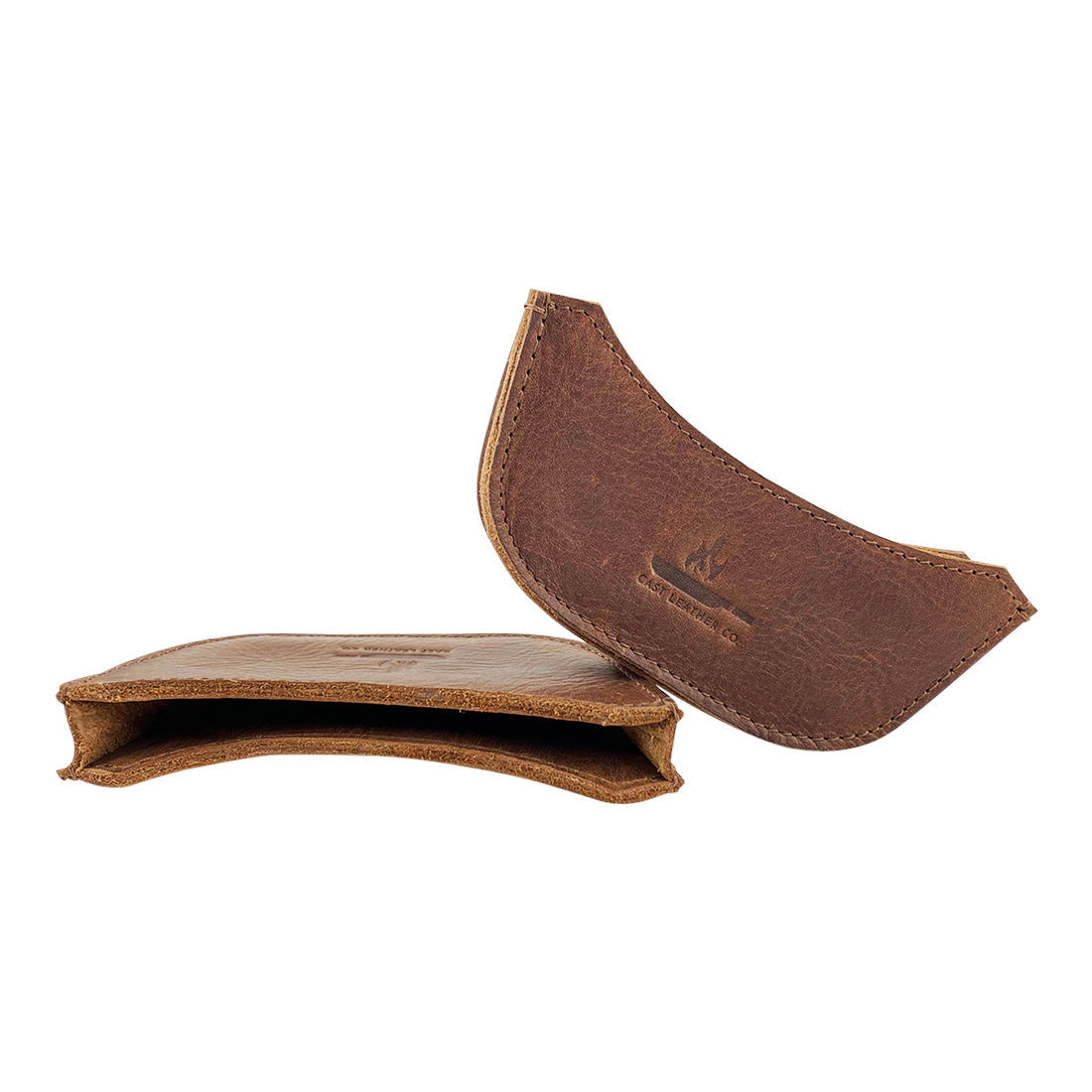 Two set of artisan leather handle covers for a wok from Cast Leather Co. This stylish Wok Sidekick provides a secure grip and is made of high-quality full grain leather, emphasizing small batch production and traditional craftsmanship.