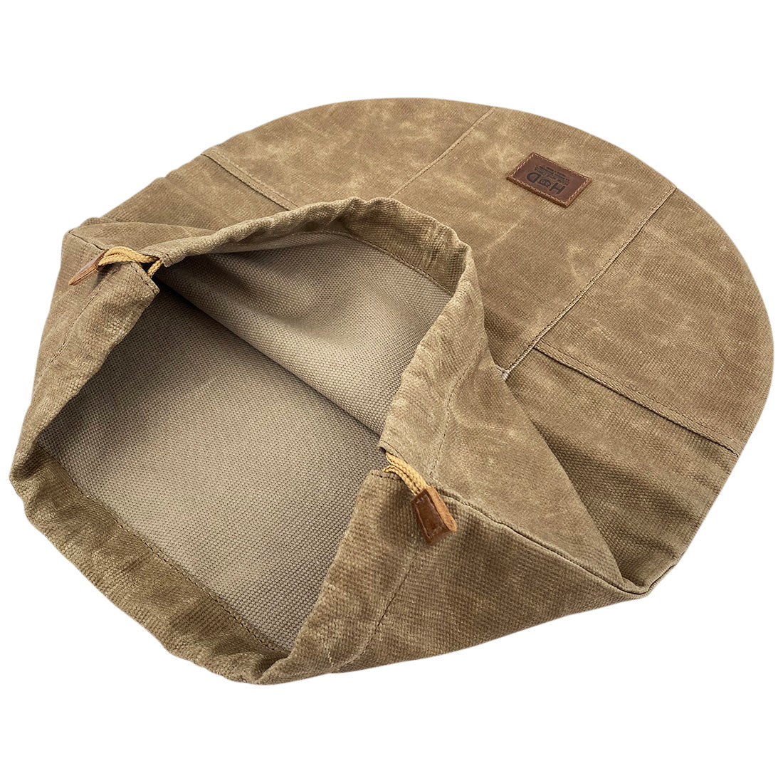 Inside view of the Skillet Bag Cover by Hide & Drink, highlighting the protective lining. Ideal for a rustic bag for a 12 Inch Frying Pan, this durable waxed canvas product illustrates small-batch artisan quality, hand cut and hand sewn in La Antigua Guatemala and Oaxaca Mexico.