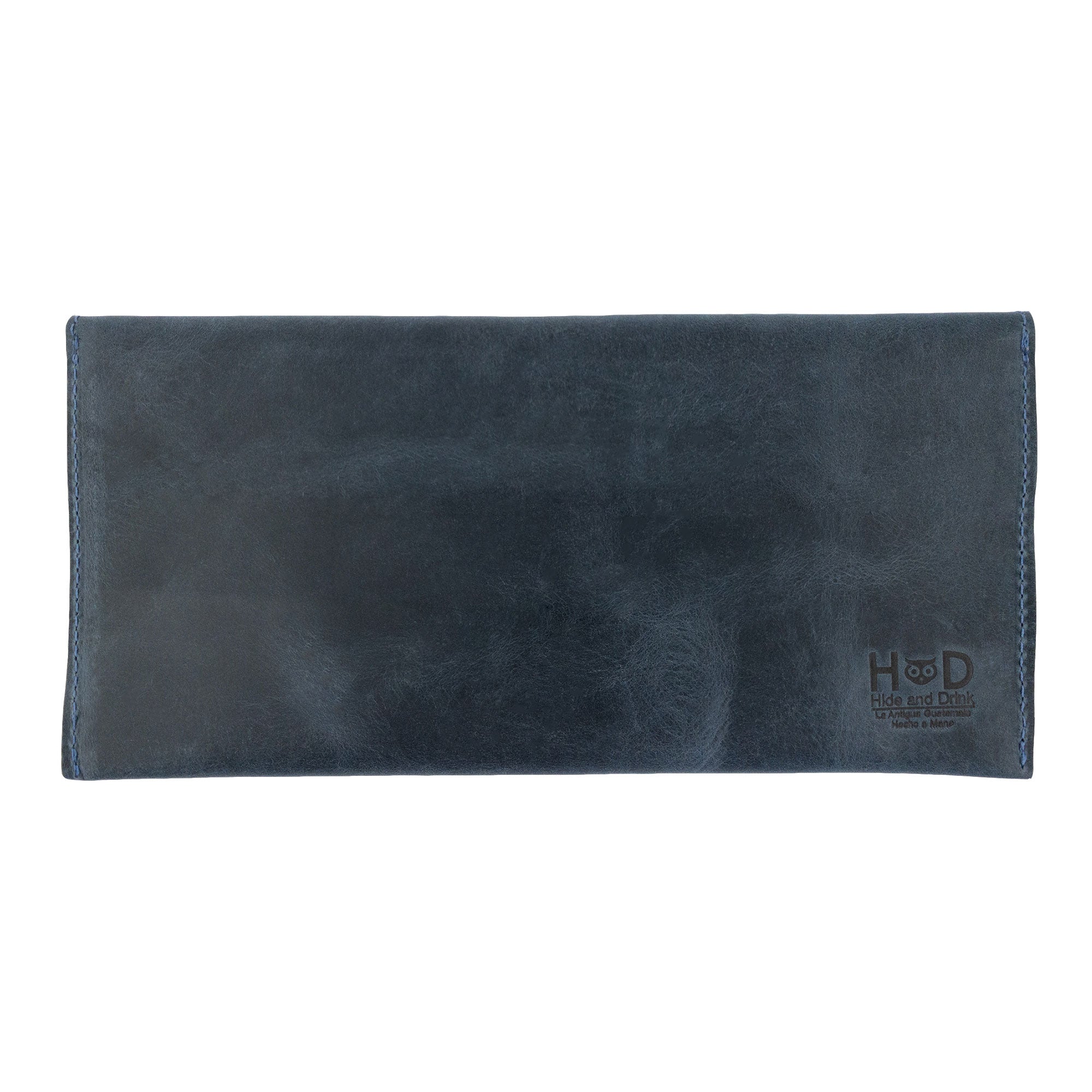 The back of Hide & Drink's navy blue Travel Hand Wallet, displaying its high-quality Full Grain Leather finish. A durable Travel Wallet, this artisan piece is hand sewn in La Antigua Guatemala & Oaxaca Mexico.