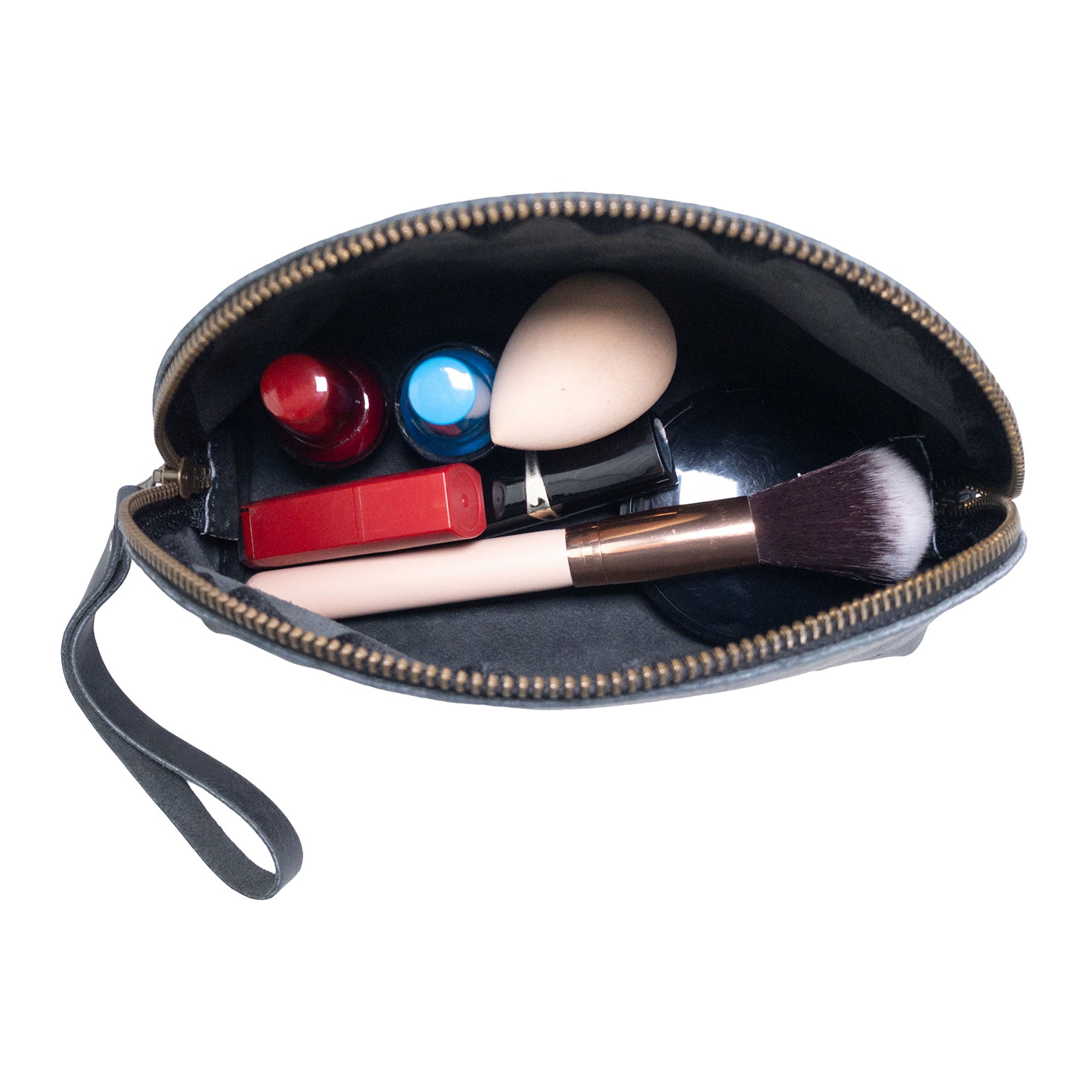Open view of the Accessory Pouch Organizer Hand Bag from Hide & Drink, filled with cosmetic essentials. This classy Cosmetic Travel Organizer with Hand Strap for Women is an ideal Makeup Bag or Classic Handbag, handcrafted to perfection in La Antigua Guatemala & Oaxaca Mexico.