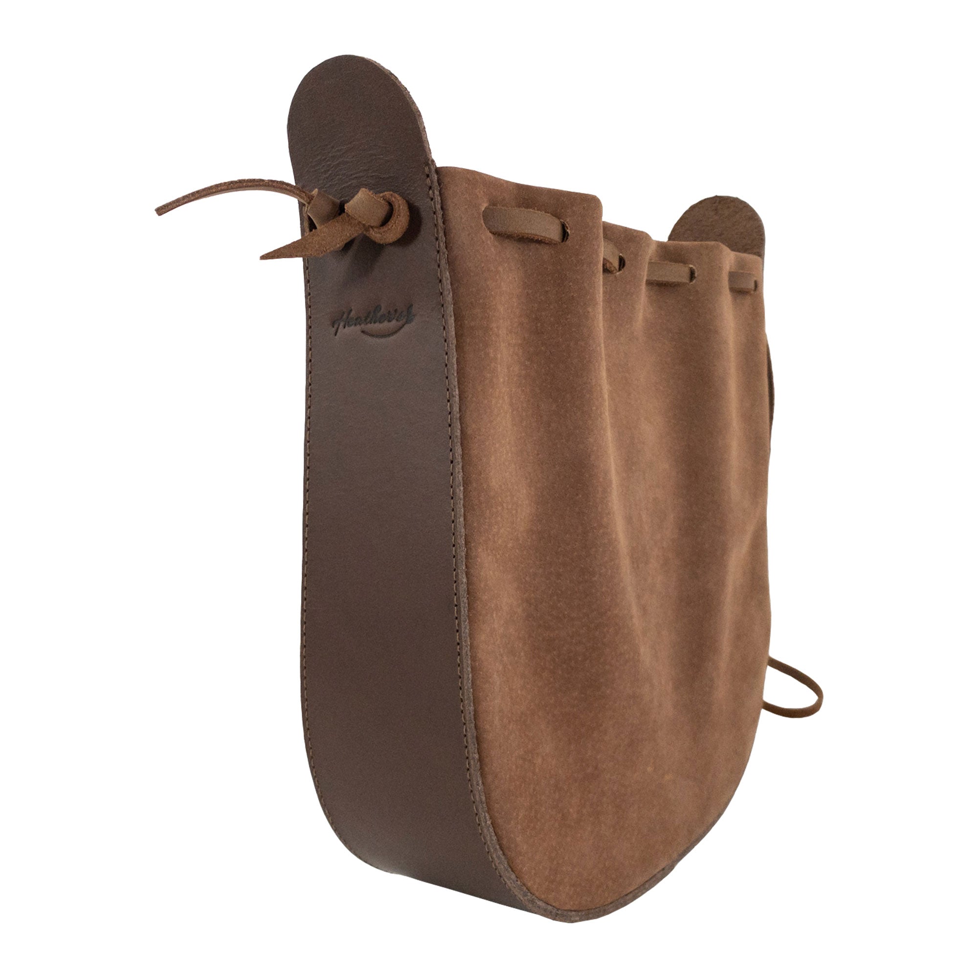 Side view of Heather's Shoulder Bag, highlighting its unique rounded shape. This beautiful bag is a multipurpose shoulder bag made from full grain leather, ideal for travel. The artisan quality reflects small batch production, featuring hand cut and hand sewn elements, fire branded as a mark of craftsmanship from La Antigua Guatemala & Oaxaca Mexico.