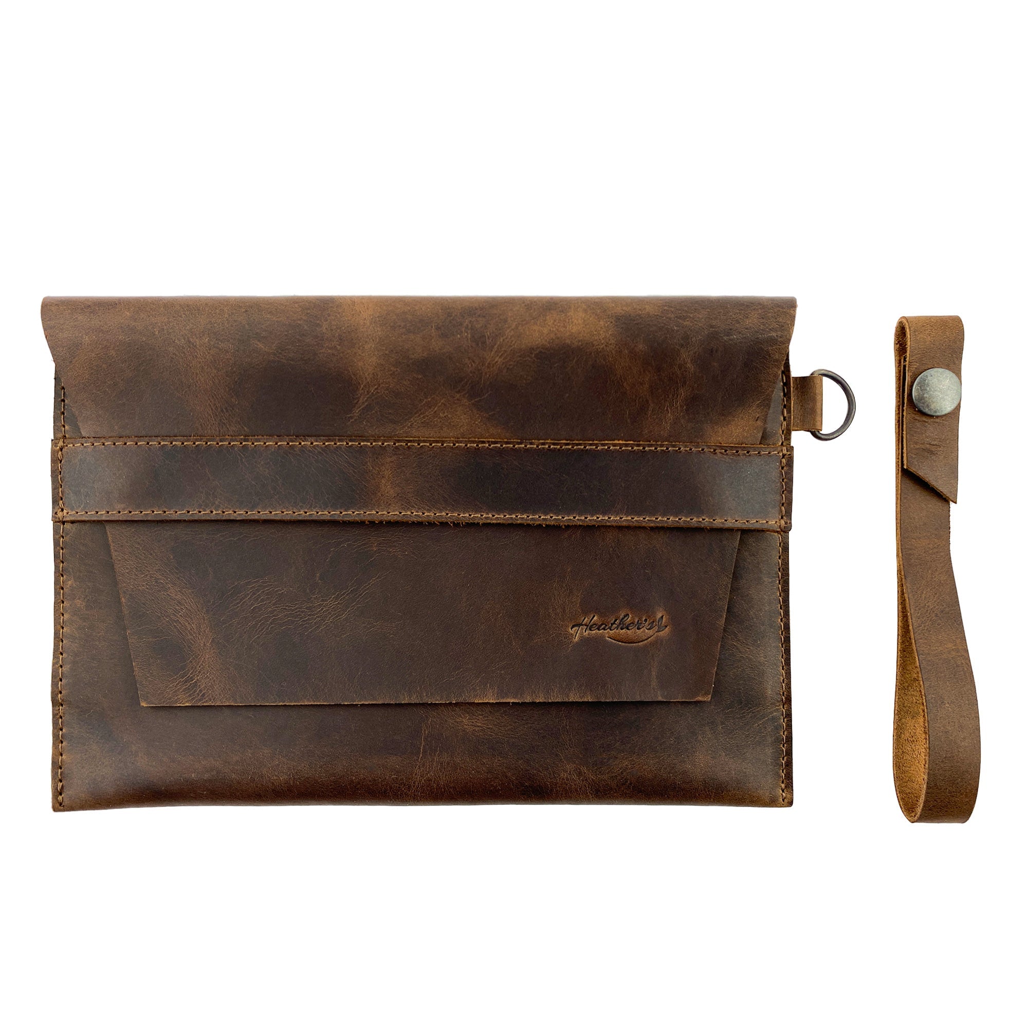 Showcasing Heather's Vintage Clutch Bag, combines functionality as a wrist wallet for cards and money with elegant design. Made from full grain leather, this artisan piece is hand cut, hand sewn, and fire branded, crafted in La Antigua Guatemala & Oaxaca Mexico.
