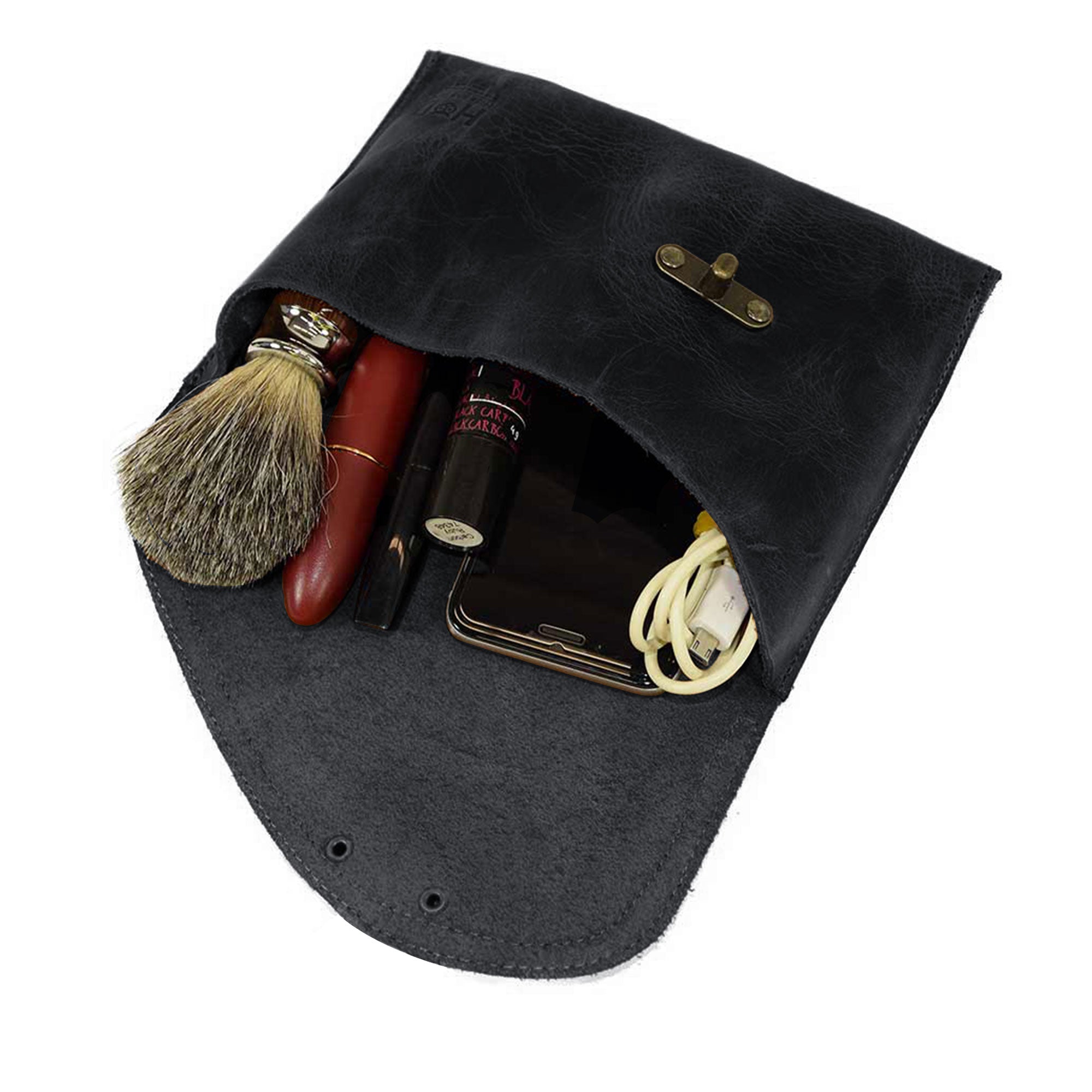 Filled black Vintage Clutch Bag by Hide & Drink, showcasing its practical interior and Full Grain Leather quality, handmade with care in La Antigua Guatemala.
