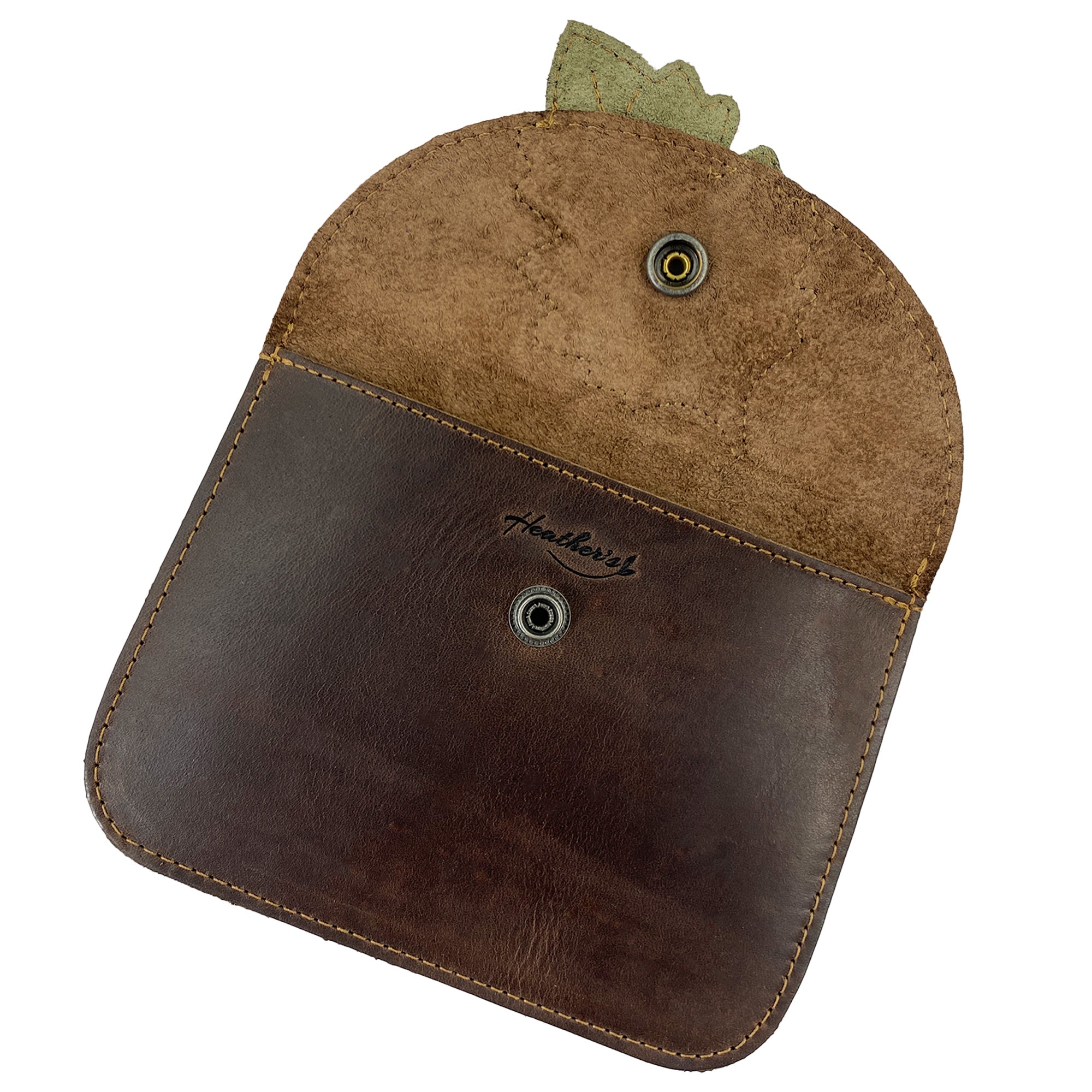 Interior view of Heather's Leaf Card Wallet, showcasing the softness and detail of the full grain leather. This Leaf Card Wallet serves as a functional soft coin & cash organizer, cable holder, and phone & accessories case. Made by artisans in La Antigua Guatemala, it features hand cut and hand sewn elements for lasting quality.