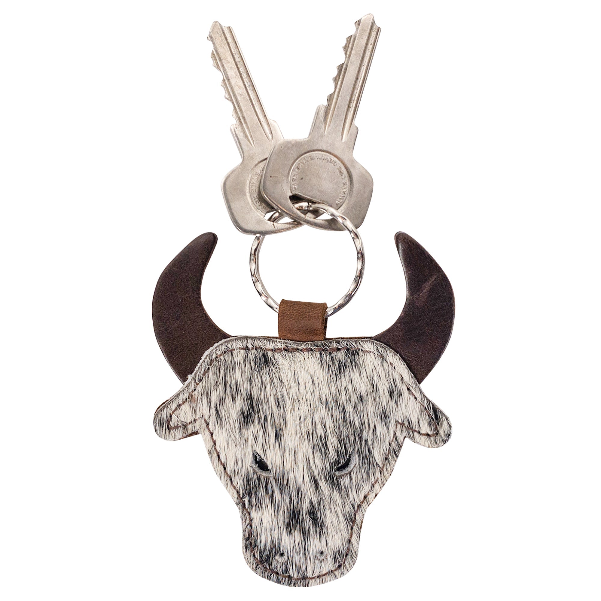 Cowboy Bull Head Keychain by Western Leather Works with keys showcasing the unique bull head shape made from hair-on-hide full grain leather. This keyring holder makes a great accessory for cowboys and cowgirls and embodies small batch production, hand cut, hand sewn, fire branded, and artisan craftsmanship from La Antigua Guatemala & Oaxaca Mexico.
