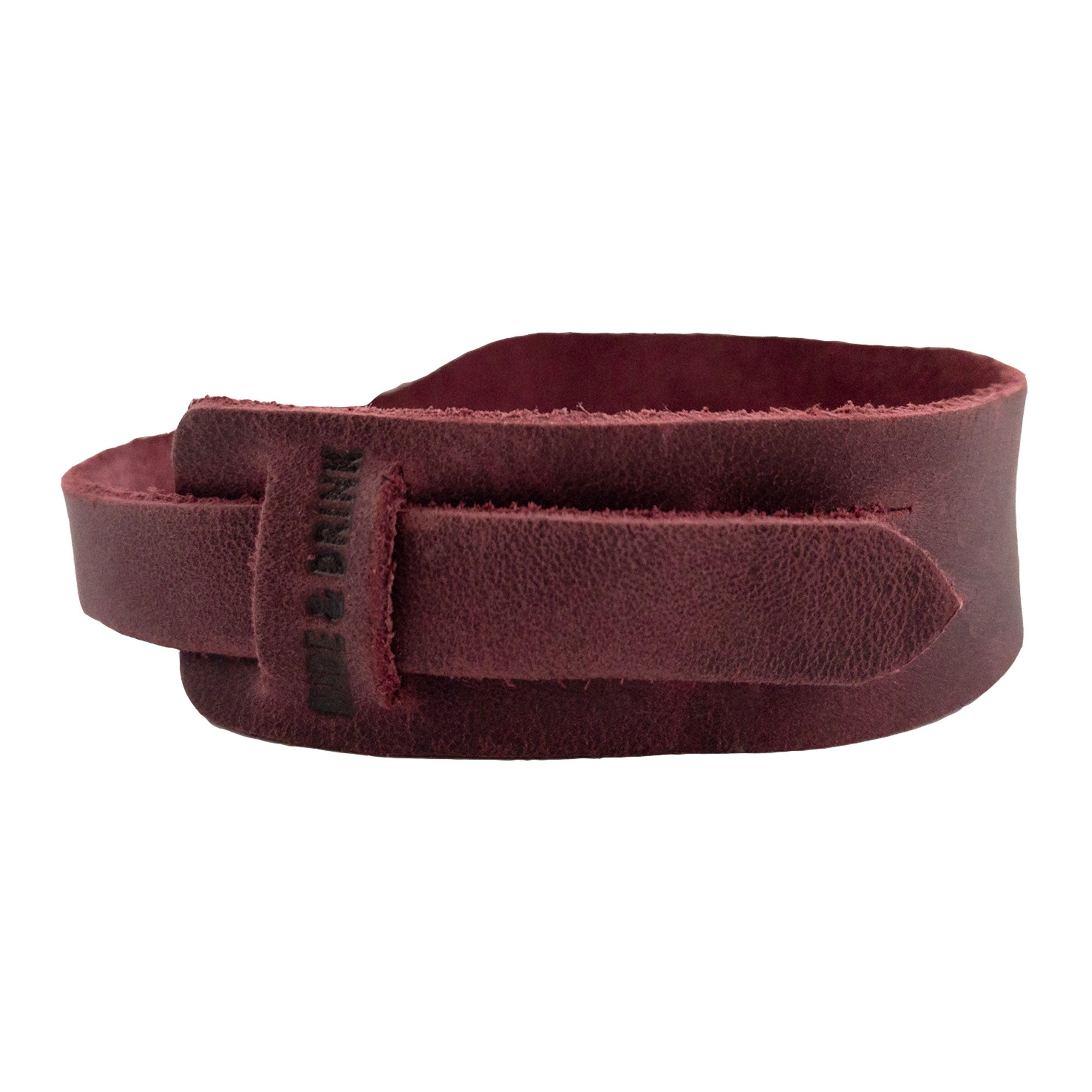 Back view of the red Hide & Drink Minimalist Wristband, demonstrating its unique craftsmanship and full grain leather finish. This rustic stylish cuff features an adjustable strap, handcrafted by artisans in La Antigua Guatemala as part of StockyardX's offerings.