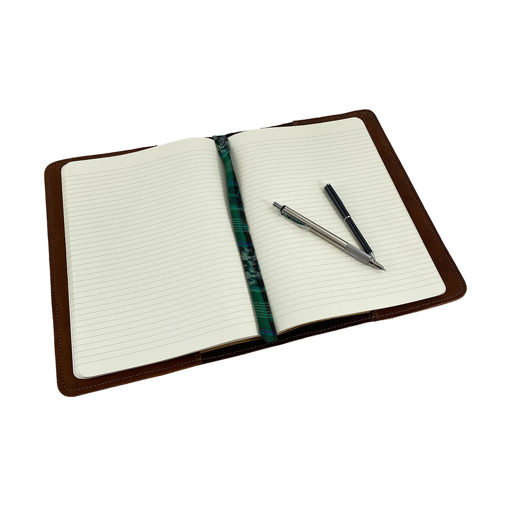 Back view of the sleek black leather Full Grain Leather Journal Cover for Moleskine Cahier XL (7.5 x 9.75 in.) by Hide & Drink, showcasing its contemporary appeal and high-quality craftsmanship, perfect for everyday use.