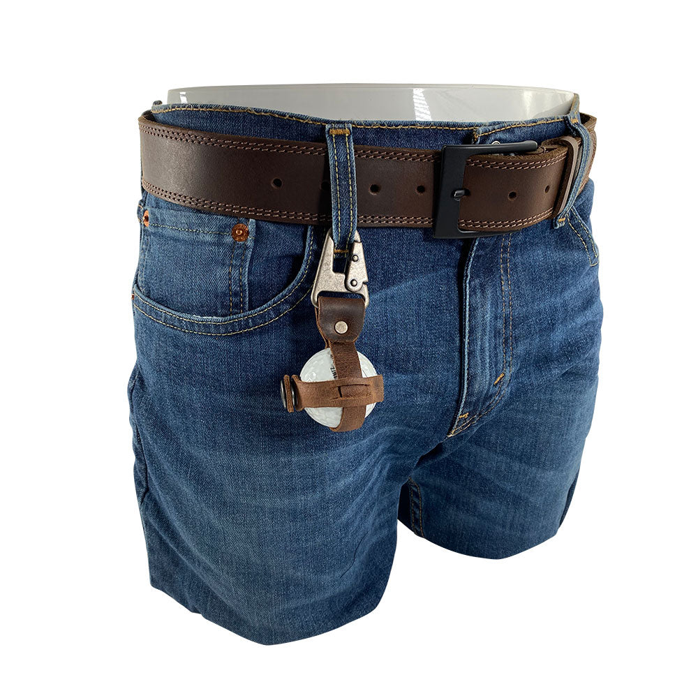 Functional Golf Ball Holder by Hide & Drink attached to a stylish pair of jeans, made from rustic full grain leather with a sturdy belt loop hook. This handmade product celebrates small batch production, expertly crafted in La Antigua Guatemala & Oaxaca Mexico.