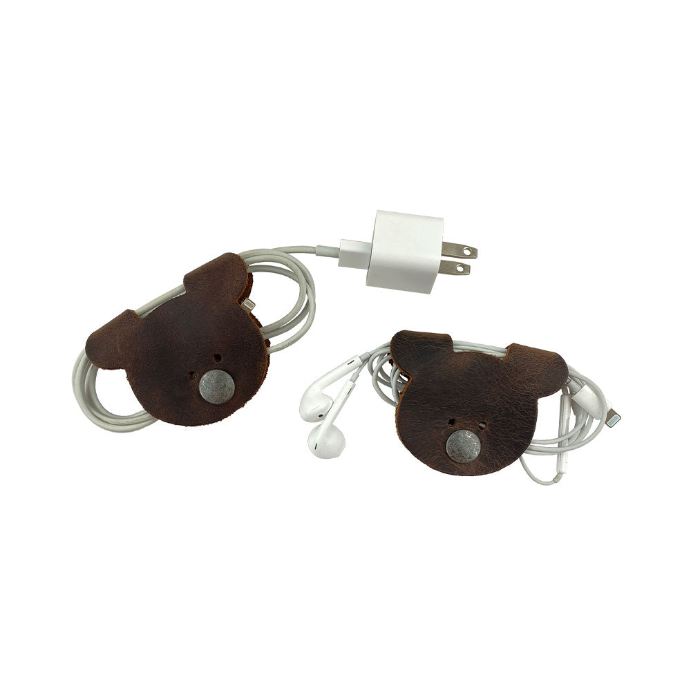Bear Shaped Cord Keeper (Cord Clam) by Hide & Drink, crafted from Full Grain Leather, ideal for cord organization and featuring artisan quality. Handmade in La Antigua Guatemala & Oaxaca Mexico, emphasizing small batch production.