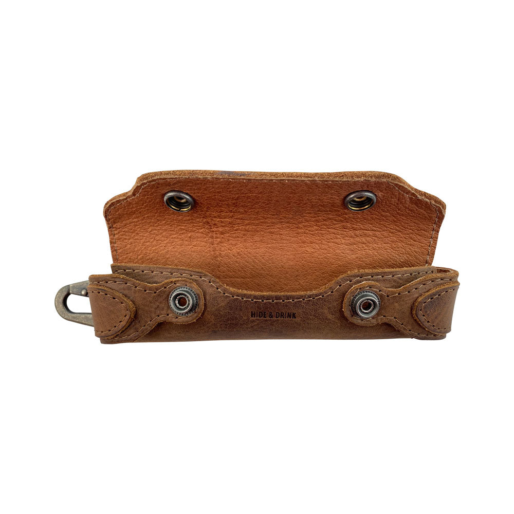 Interior view of Hide & Drink’s Harmonica Case, revealing its functional design for securing your harmonica. Made from high-quality full grain leather, this instrument cover epitomizes artisan craftsmanship and small batch production. Ideal for musicians seeking durable and beautiful accessories.