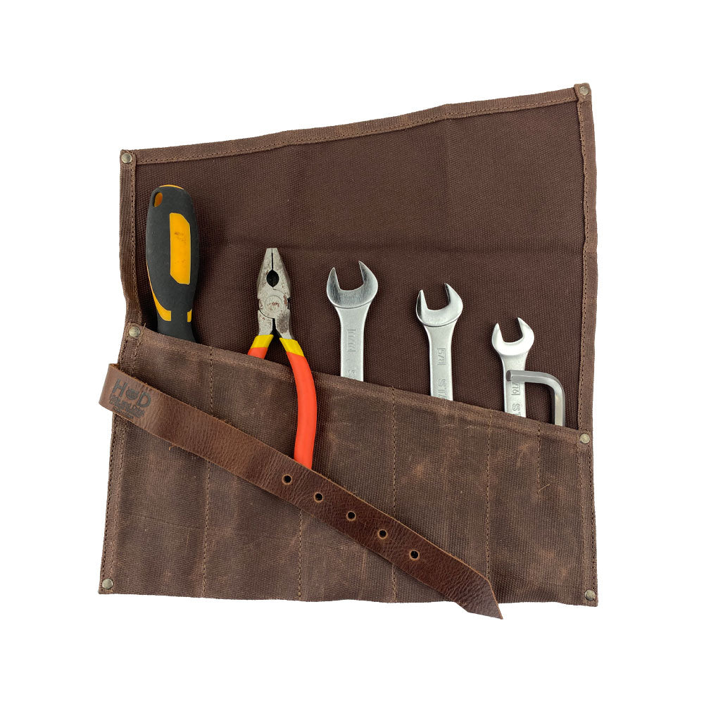 A compact view of the Large Tool Roll from Hide & Drink, showcasing its 6 slots. This Portable Carry-On Pouch is ideal for organizing woodworking tools. Made from premium waxed canvas and full grain leather variations, this artisan product highlights small batch production, hand cut and sewn in La Antigua Guatemala & Oaxaca Mexico.
