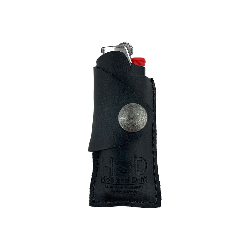 Hide & Drink Lighter Protective Case in black, blending contemporary style and traditional artisan craftsmanship. Made with full grain leather in La Antigua Guatemala & Oaxaca Mexico. Includes tags: Lighter Protective Case, Full Grain Leather, Artisan.