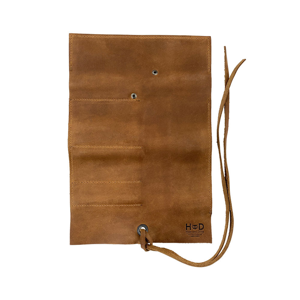 Hide & Drink Multi Purpose Pencil Roll with its smart compartments designed for organizing supplies. Perfect for craft and work environments, this rustic, handmade pouch embodies quality and artisan craftsmanship.