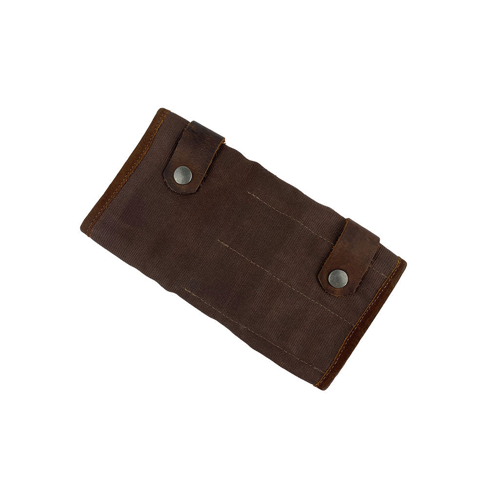 Folded view of Hide & Drink's Barber Tool Roll, a stylish Snap Tool Roll Up Bag with 14 Slots perfect for organizing scissors & screwdrivers. Made from high-quality Full Grain Leather, this portable carry case emphasizes StockyardX's artisan craftsmanship and dedication to small batch production, hand cut, hand sewn, and fire branded in La Antigua Guatemala & Oaxaca Mexico.