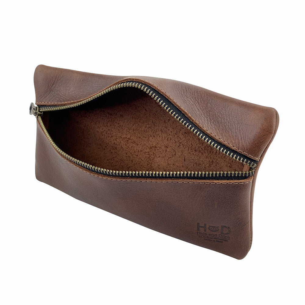 Hide & Drink Utility Cord Pouch showcasing its unique design with leather finish. This artistic utility & charger case for MacBook, iPad & Laptop doubles as a cable organizer, crafted by artisans in La Antigua Guatemala & Oaxaca Mexico.