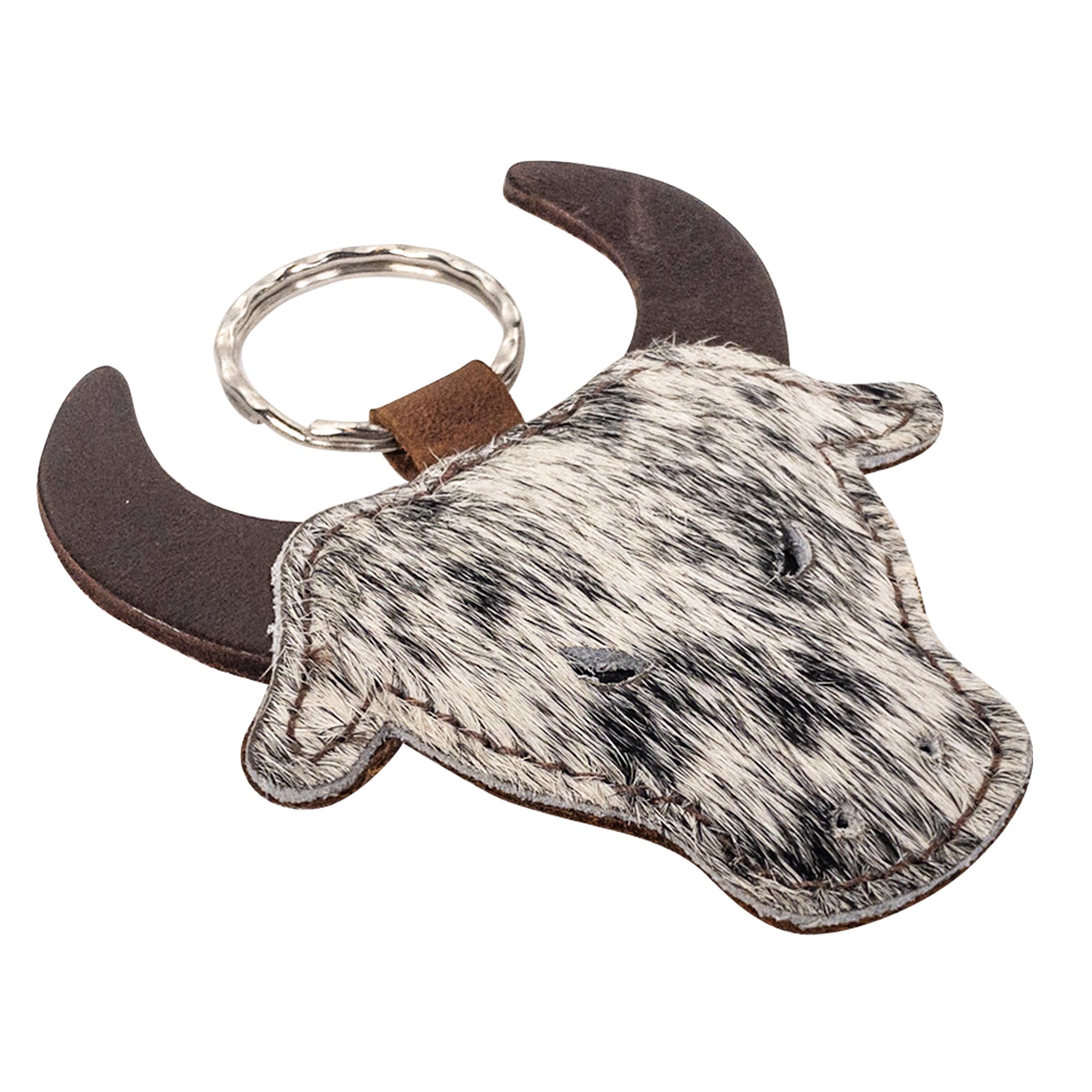 Close-up of the Cowboy Bull Head Keychain by Western Leather Works, highlighting the hair-on-hide texture and bull horns. This keyring holder is a fantastic accessory for cowboys and cowgirls and is made with care through small batch production, hand cut, hand sewn, fire branded, artisan techniques in La Antigua Guatemala & Oaxaca Mexico.
