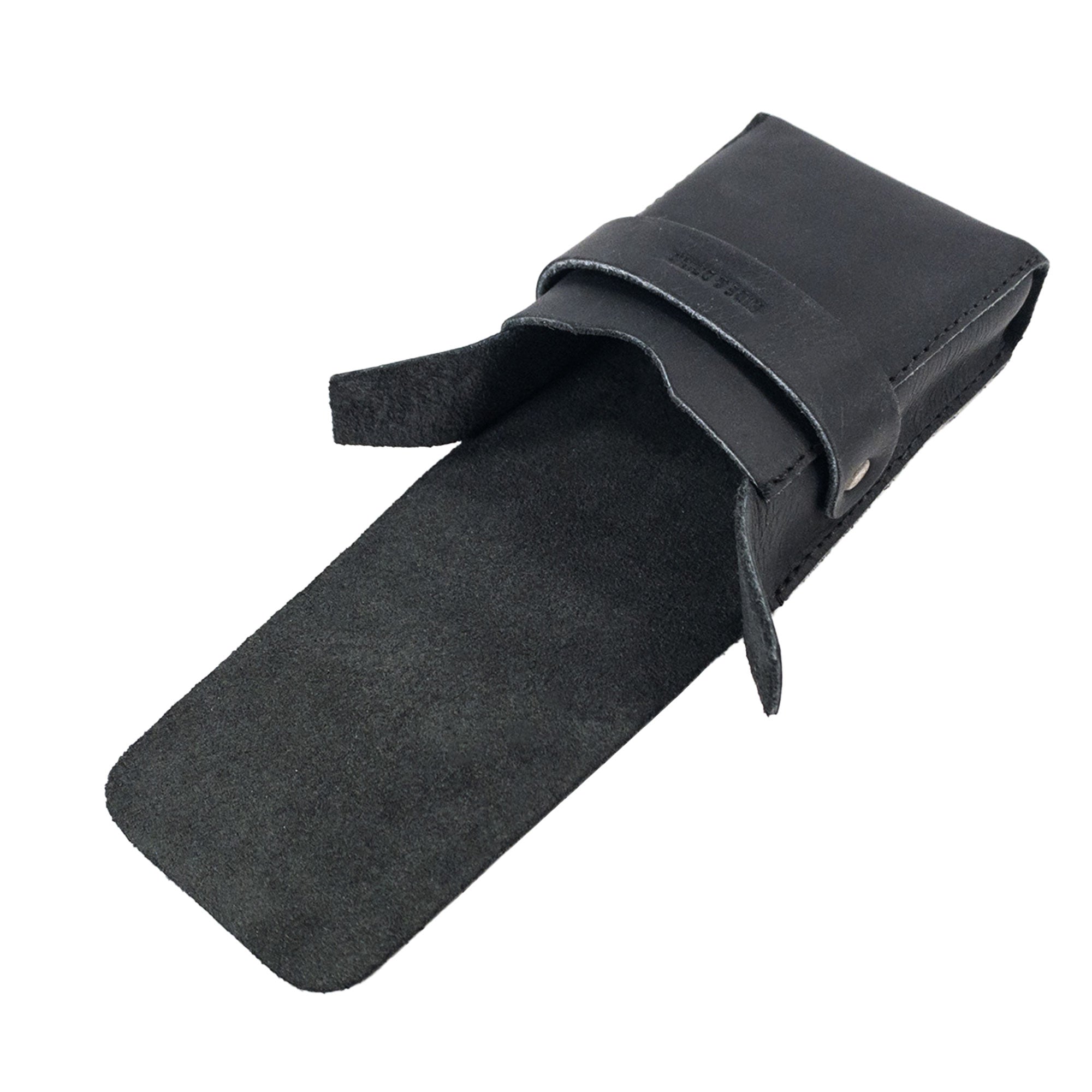 Open view of Hide & Drink's Playing Card Case showing the soft suede interior. Ideal for securely storing your classic playing cards (not included), this travel accessory is made of full grain leather. Handcrafted by artisans in La Antigua Guatemala, it's a quality product from StockyardX.