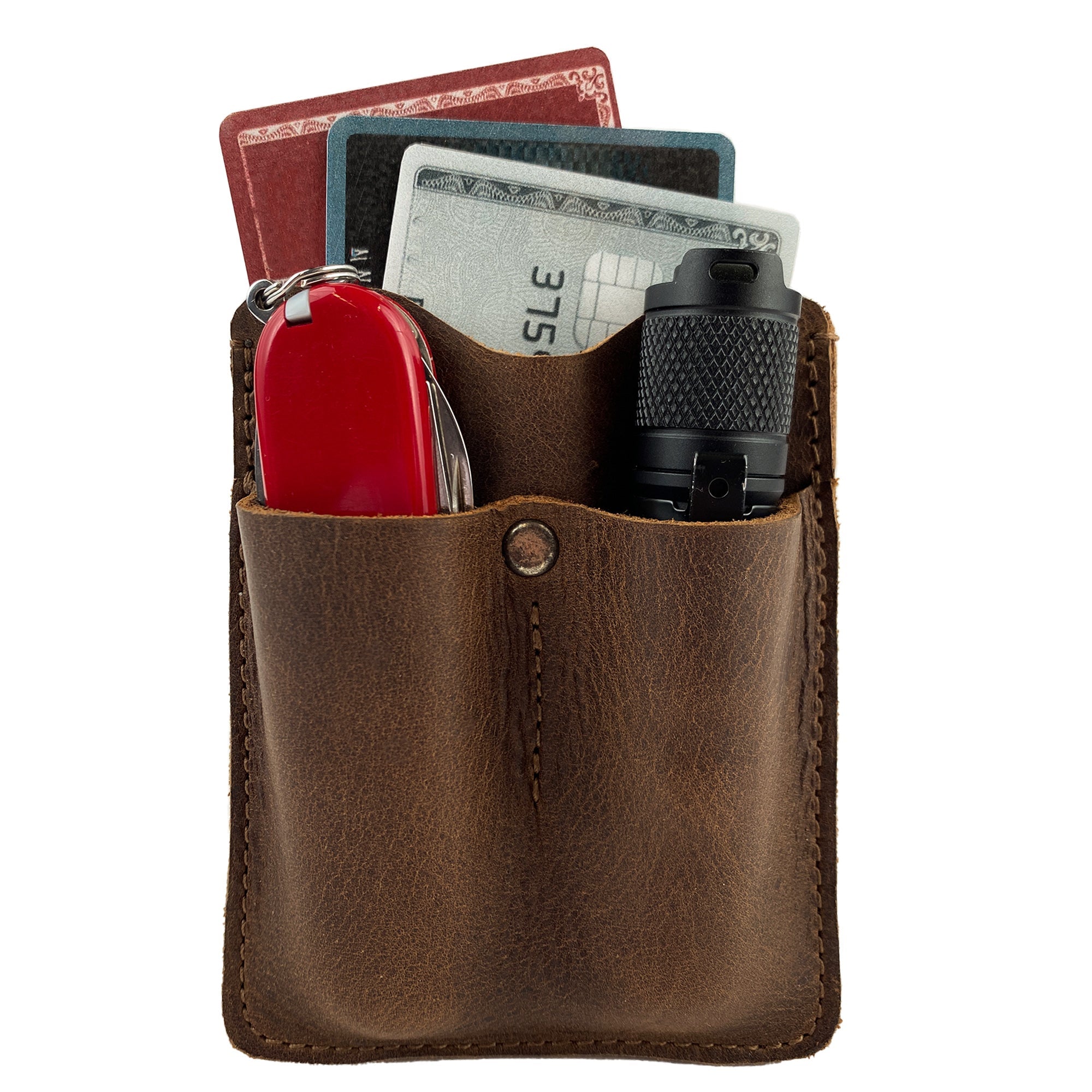 The Hide & Drink Card Holder with Small Tool Slots filled with cards, a knife, and a flashlight. This artisan-made, full grain leather card holder offers a stylish and efficient way to organize workshop accessories and is crafted in La Antigua Guatemala.
