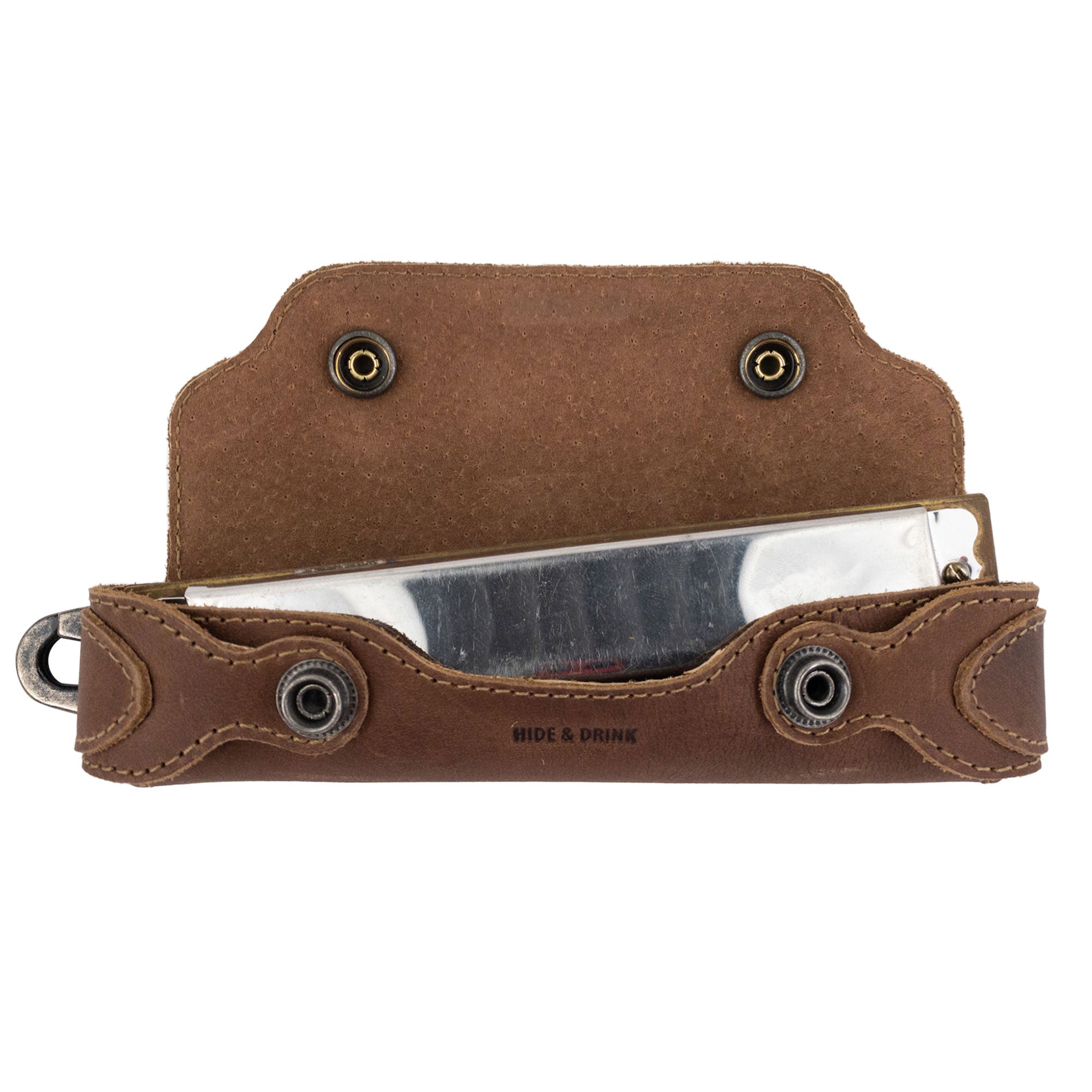 Harmonica Case from Hide & Drink with a harmonica inside, demonstrating excellent protection. This full grain leather musician accessory is handcrafted, illustrating the quality of artisan skills from La Antigua Guatemala.