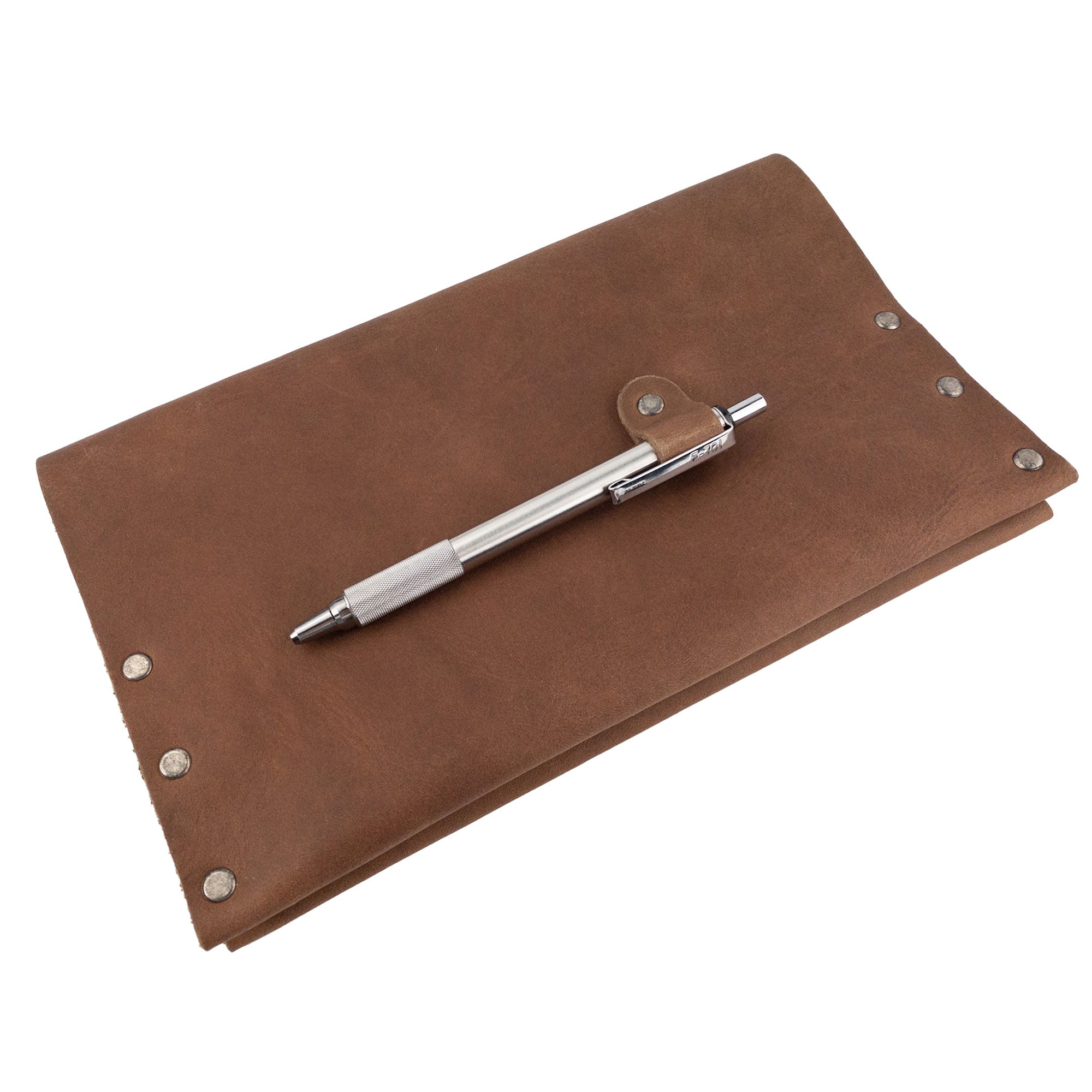 The Riveted Journal Cover (5 x 8.50 in.) from Hide & Drink shown with a pen, highlighting its functionality and style. This classic sleeve in vintage full grain leather combines hand cut and sewn artistry, perfect for organization and creativity, designed by artisans in La Antigua Guatemala & Oaxaca Mexico.