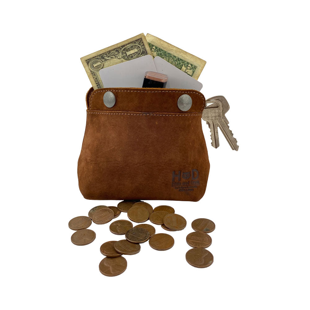 Hide & Drink Double Snap Pouch filled with coins and cash, perfectly suited for use as a coin purse or cash holder. This full grain leather pouch is a testament to artisan craftsmanship and small batch production in La Antigua Guatemala.