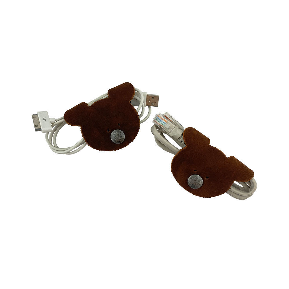 Bear Shaped Cord Keepers (Cord Clam) by Hide & Drink, perfect for organizing USB cords, crafted from durable Full Grain Leather with an artisan touch. Handmade in La Antigua Guatemala & Oaxaca Mexico, highlighting small batch production.