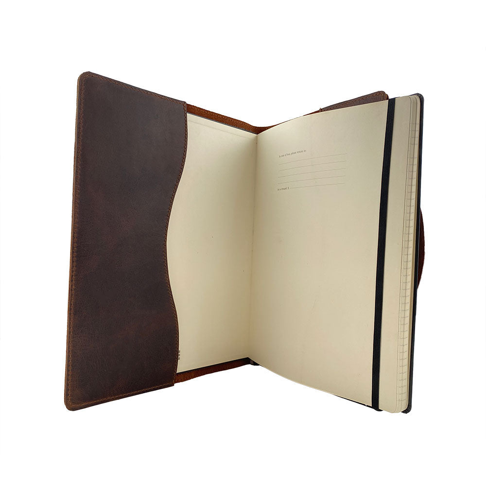 An enticing interior shot of the Hard Cover Notebook Protector (Notebook NOT Included) by Hide & Drink, loaded with handwritten notes. This journal cover is made for Moleskine Hard Cover Sketchbook XXL Size (8.5 x 11 in.), Notebook NOT Included, crafted from durable Full Grain Leather, highlighting StockyardX’s small batch production standards through hand cut, hand sewn, and fire branded craftsmanship by artisans. Handmade in La Antigua Guatemala & Oaxaca Mexico.