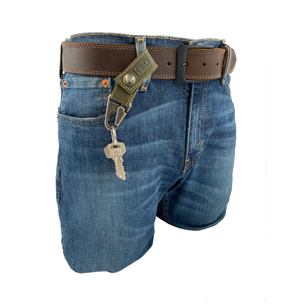 Hide & Drink Key Ring Holder showcased on denim shorts, perfect for stylish key organization with its sturdy brass clip. Made with Full Grain Leather, this artisan product reflects Small Batch Production and precise craftsmanship.