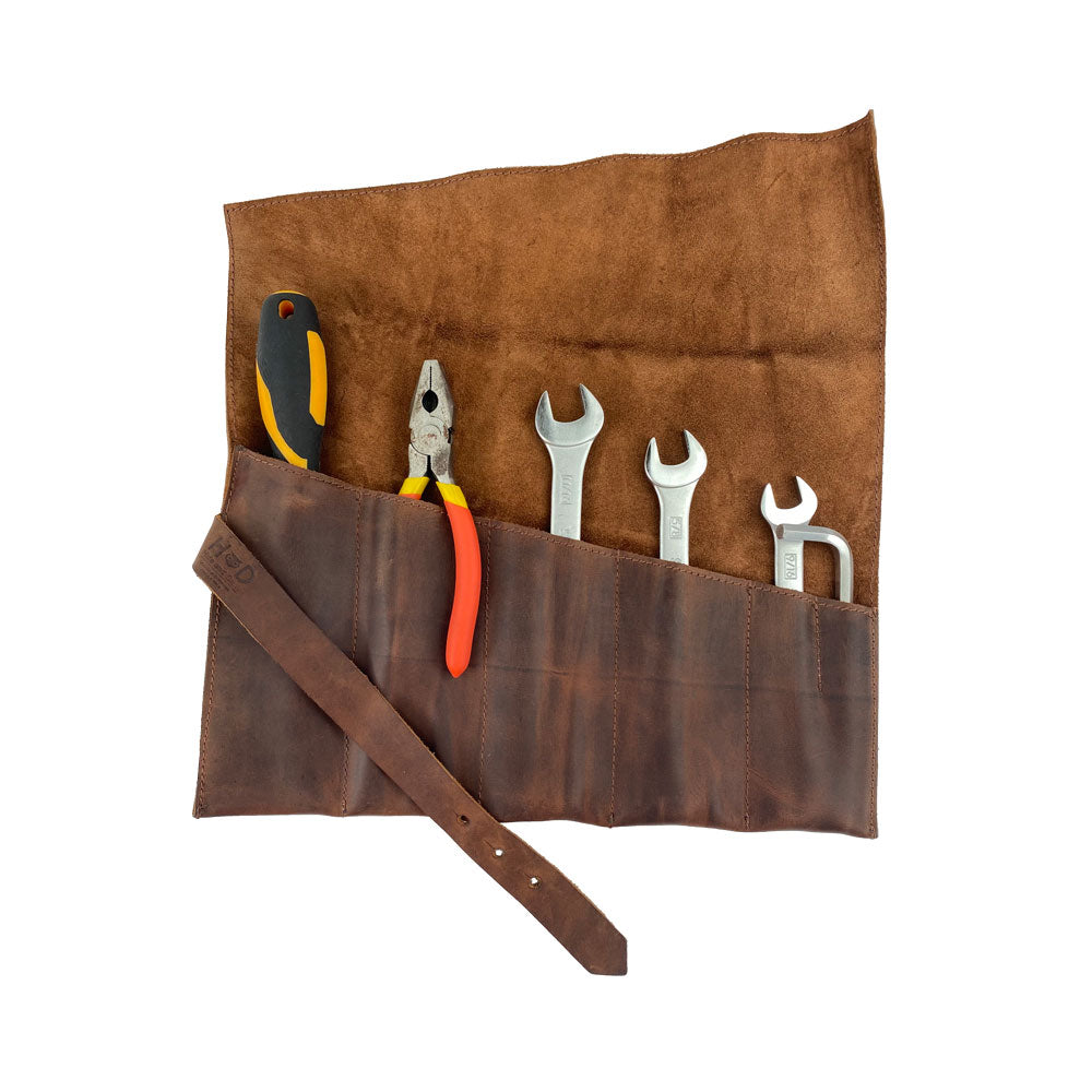 The Large Tool Roll by Hide & Drink featuring tools neatly organized in 6 slots. This Portable Carry-On Pouch is excellent for woodworking tools storage. Crafted with waxed canvas and full grain leather variations, this small batch artisan product is completely hand cut and sewn, showcasing quality made in La Antigua Guatemala & Oaxaca Mexico.