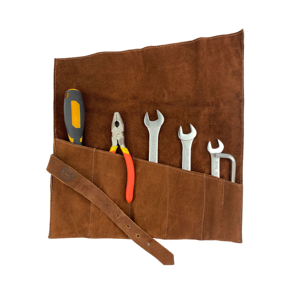 The Large Tool Roll by Hide & Drink showcasing the inclusion of working tools. This Portable Carry-On Pouch has 6 slots, ideal for woodworking tools organization. With a design using waxed canvas & full grain leather variations, this artisan product stands out as small batch production, crafted with care by artisans in La Antigua Guatemala & Oaxaca Mexico.