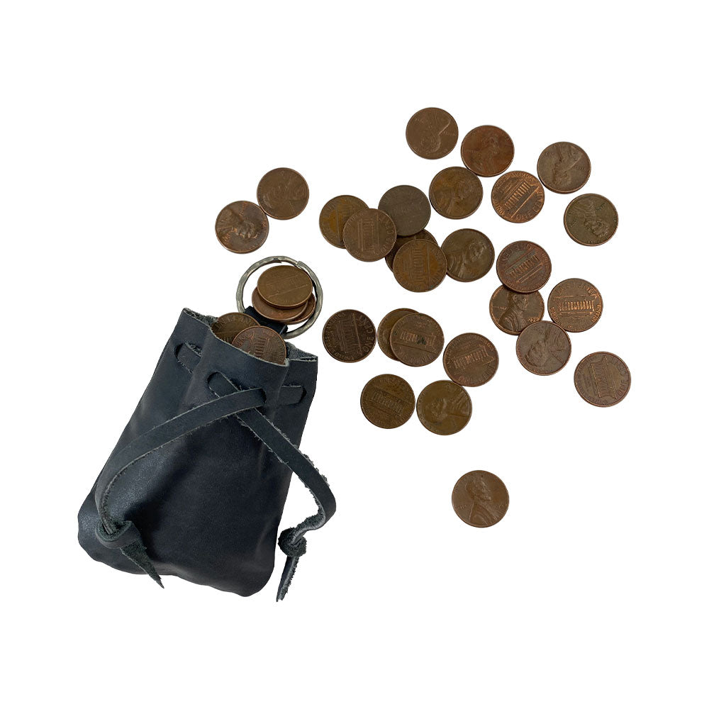 AirPods stored in the Mini Medieval Pouch Keychain by Hide & Drink, showcased in black leather. This tiny bag with keyring is not only stylish but also efficiently serves as a coin pouch while accentuating artisan craftsmanship from La Antigua Guatemala.