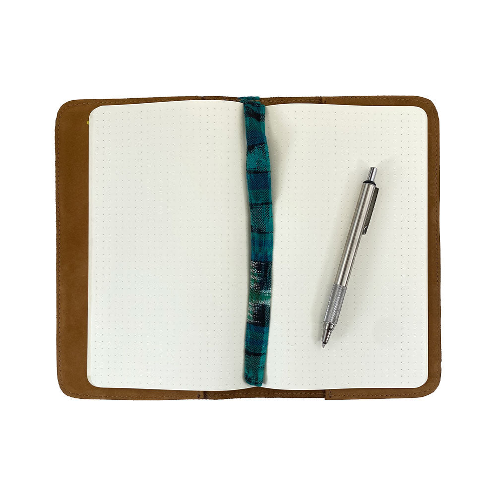 Open view of a brown Journal Cover for Moleskine Cahier L (5 x 8.25 in.) by Hide & Drink, displaying its spacious interior. This refillable journal cover is perfect for large size (5 x 8.25 in.) notebooks, crafted from beautiful full grain leather.