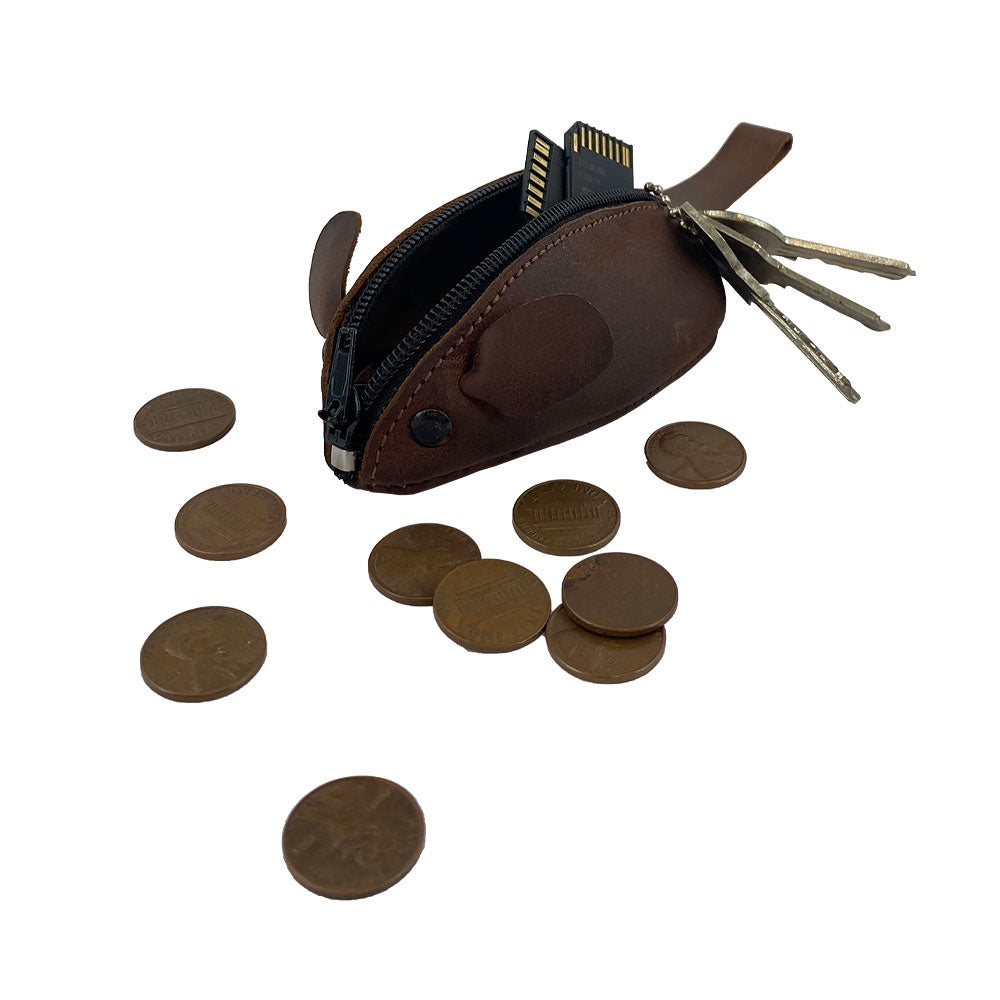 The Hide & Drink Mouse Coin Pouch is open with loose change inside, demonstrating its functionality as a change pouch. Crafted from full grain leather, this pocket case for coins is a playful and practical travel accessory, handmade in La Antigua Guatemala.