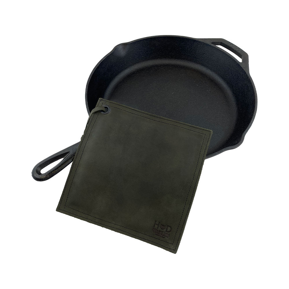 Close-up of the Hide & Drink Pot Pad in rich blue leather. This rustic hot pot pad is perfect for protecting surfaces, crafted with durability in mind.