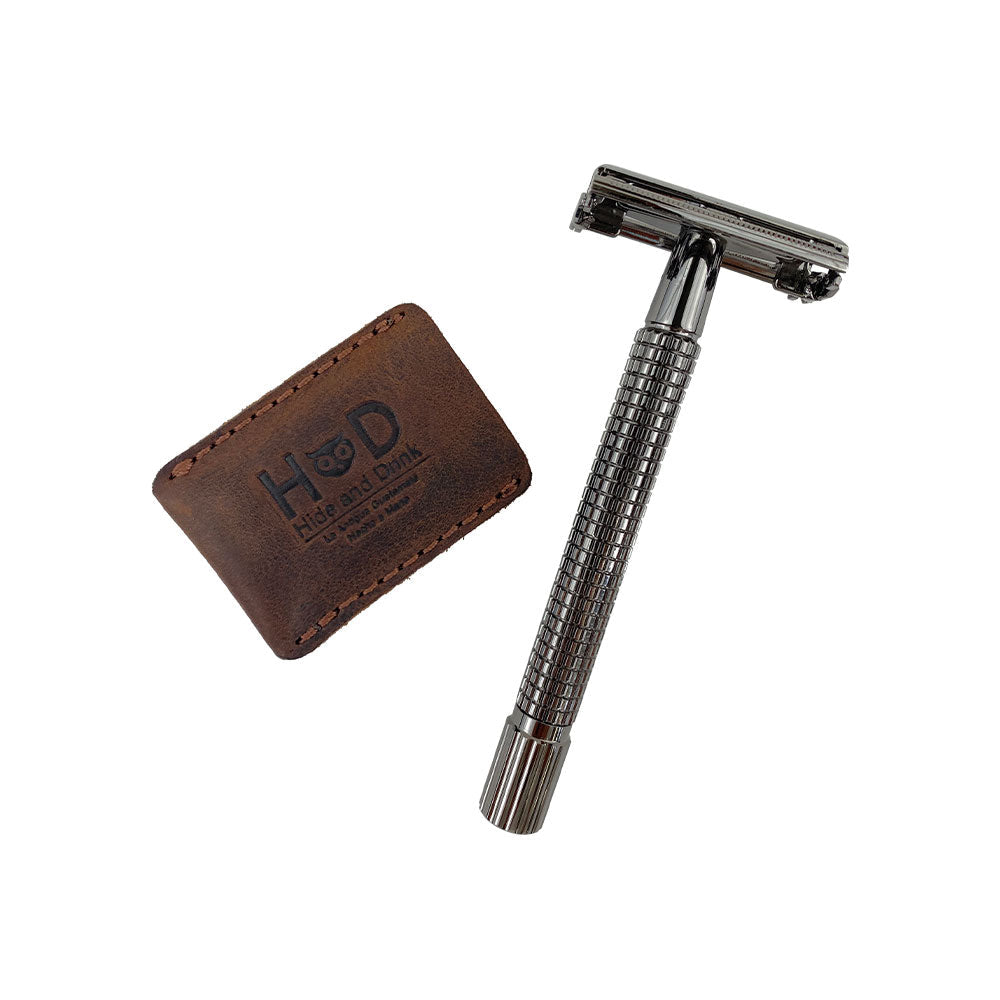 Hide & Drink Razor Head Cover next to a double edge safety razor, demonstrating its protective capabilities and handmade quality. This full grain leather sheath is perfect for travel while showcasing artisan craftsmanship from La Antigua Guatemala & Oaxaca Mexico.