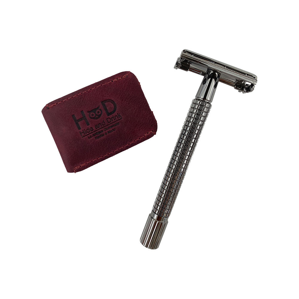 A stylish setup featuring the Razor Head Cover from Hide & Drink alongside a double edge safety razor. This full grain leather protective sheath enhances your shaving experience while representing small batch artisan craftsmanship.