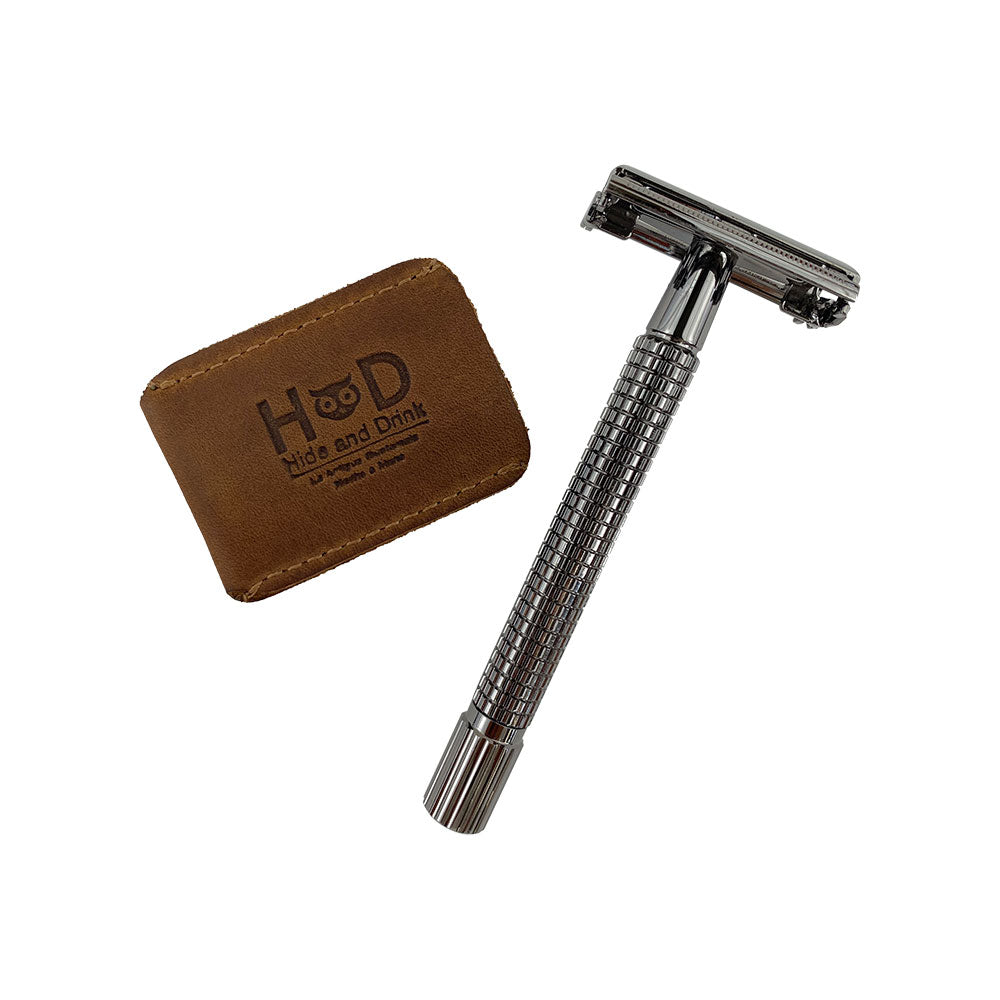 Hide & Drink Razor Head Cover displayed alongside a double edge safety razor, crafted from full grain leather. This handmade protective sheath is perfect for travel, highlighting the artisan quality and small batch production from La Antigua Guatemala and Oaxaca Mexico.