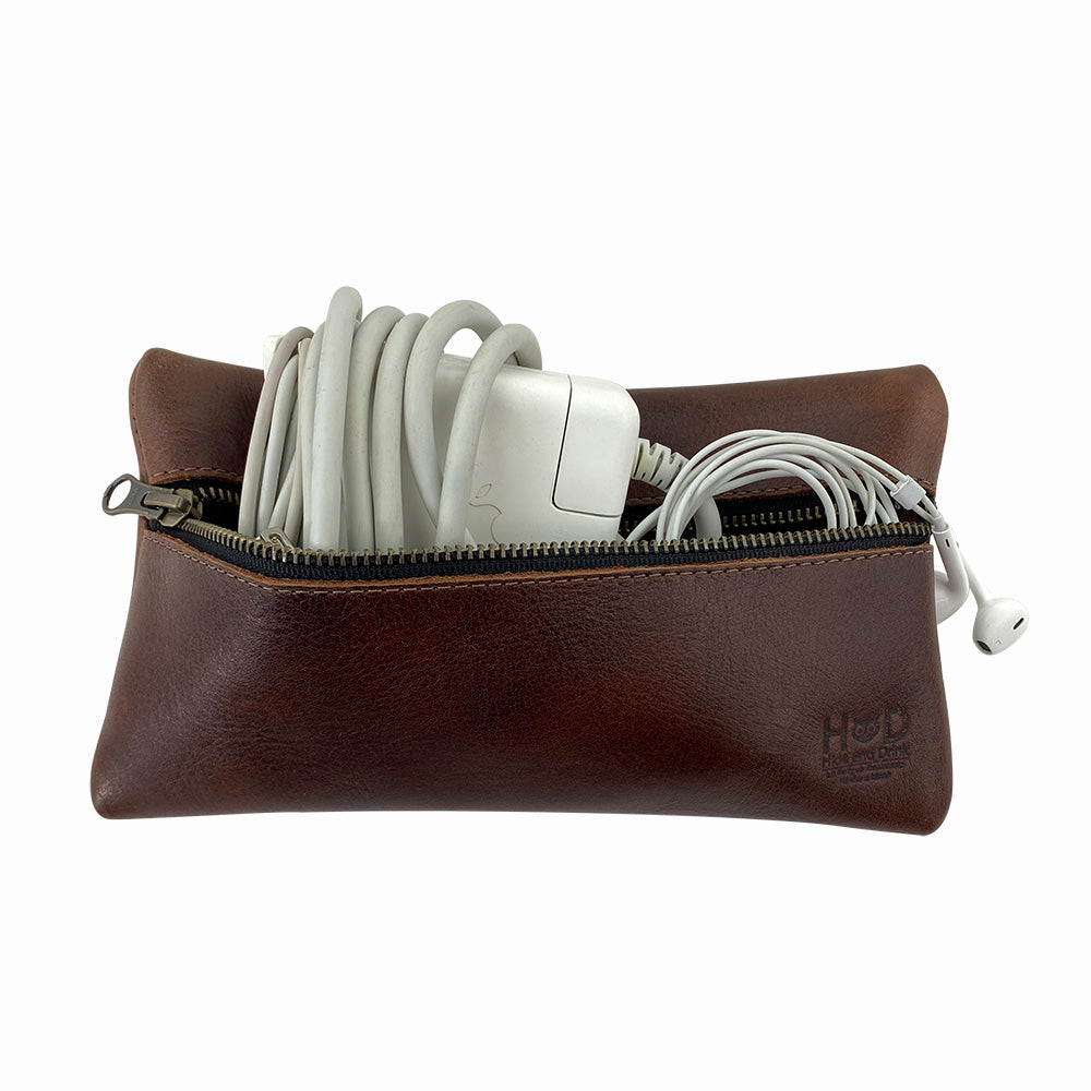 Hide & Drink Utility Cord Pouch in a stylish presentation, highlighting its durable zipper. This all-purpose utility & charger case for MacBook, iPad & Laptop serves as an efficient cable organizer, showcasing quality craftsmanship from La Antigua Guatemala & Oaxaca Mexico.