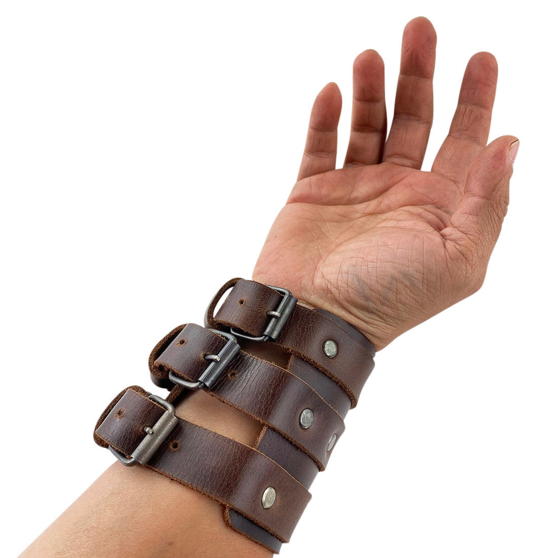 Another hand modeling the 3 Buckle Bracelet from Hide & Drink while highlighting the stylish design and adjustable features. This trendy wristband made from full grain leather represents high craftsmanship in men’s fashion accessories.