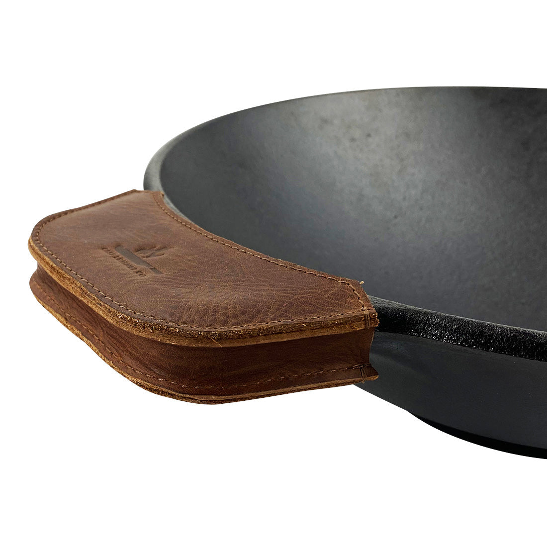 Close-up of the leather handle on a wok, featuring the Wok Sidekick by Cast Leather Co. This cooking accessory, made from full grain leather, showcases the artisan touch with its hand cut and hand sewn design that adds rustic elegance to any kitchen.