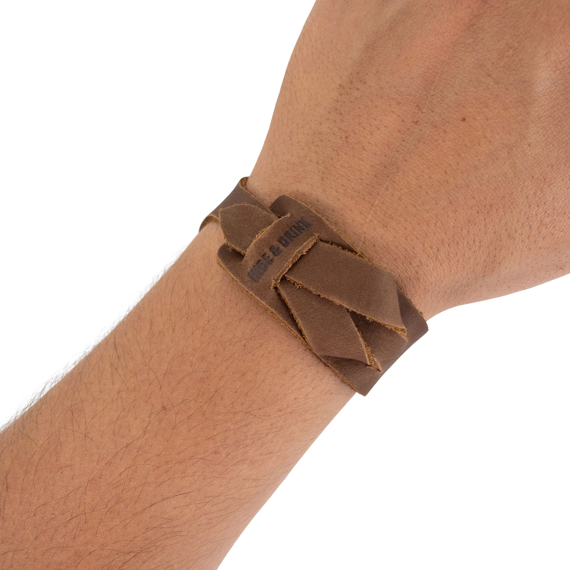 Hide & Drink‚Äôs Minimalist Wristband worn, showcasing the light brown leather‚Äôs unique tone and handcrafted quality. This adjustable cuff is a stylish bracelet that embodies artisan craftsmanship and care from StockyardX in La Antigua Guatemala.